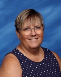 A person wearing glasses and a polka dot shirtDescription automatically generated